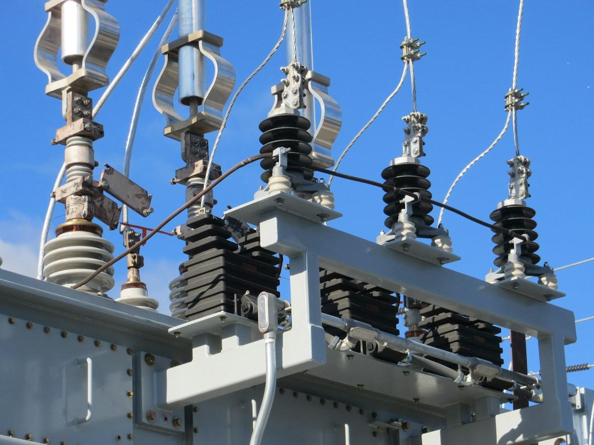 High-voltage insulators and connections mounted on a steel frame