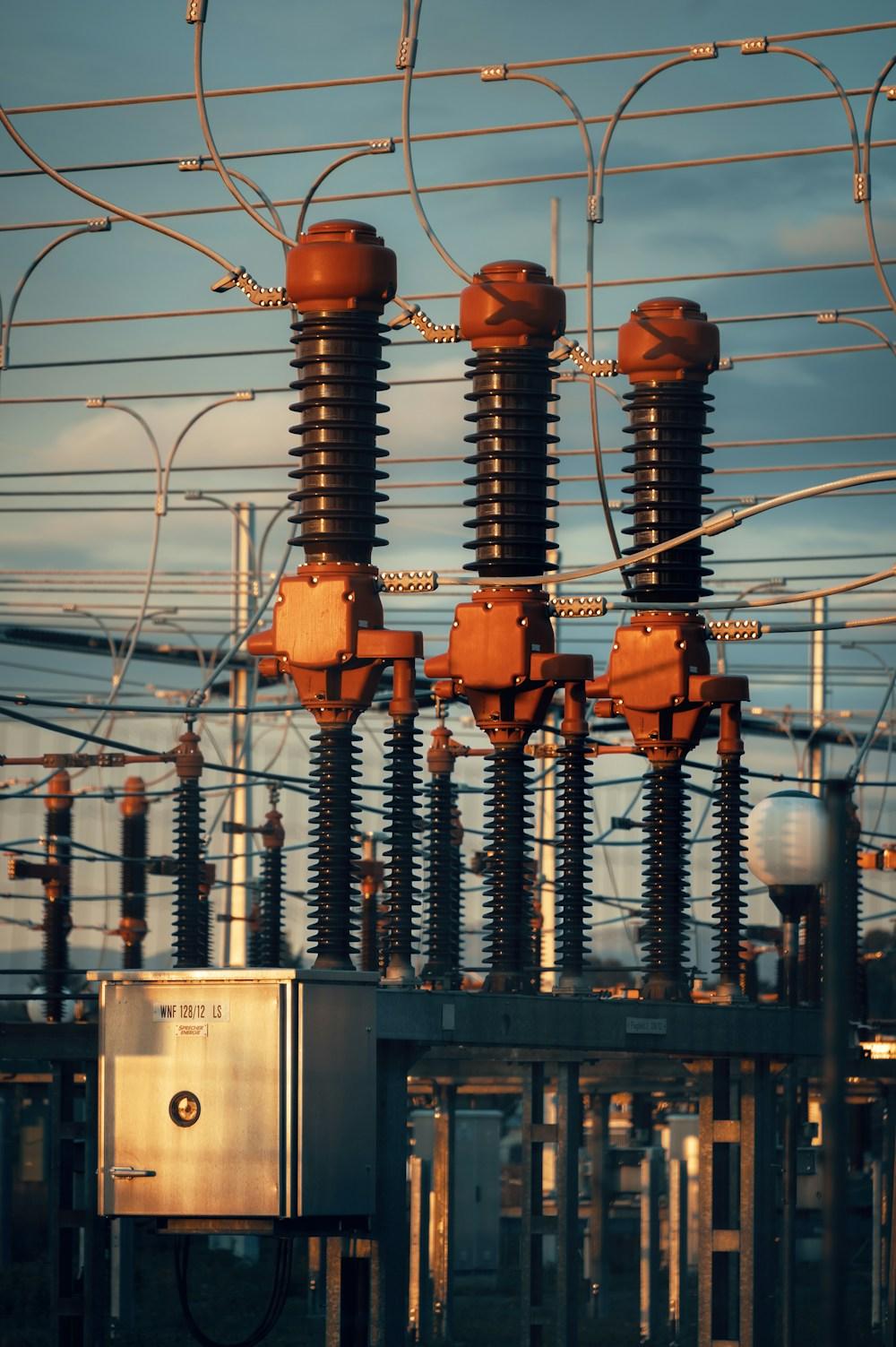 High-voltage bushings with overhead line connections at a substation at dusk